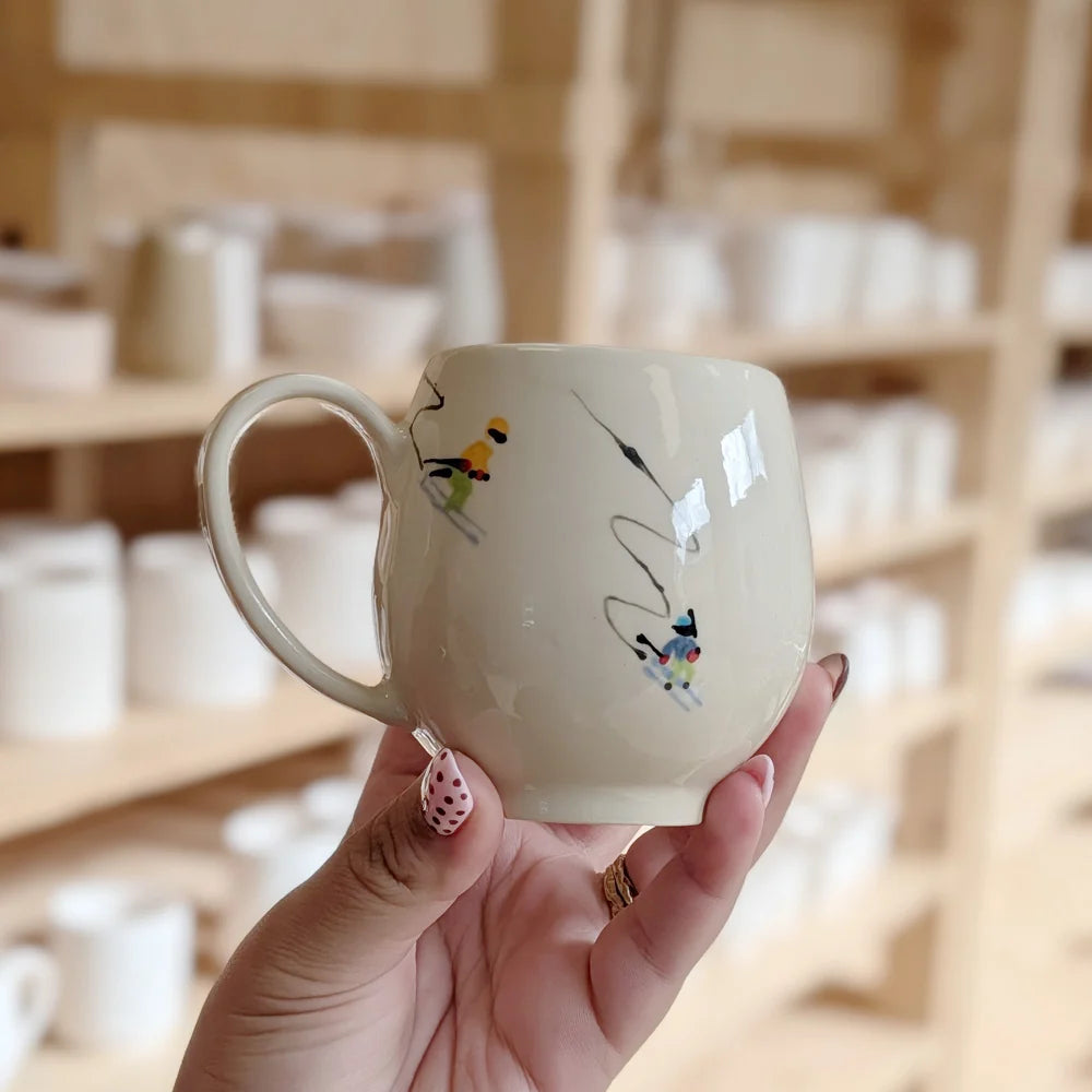 A hand-painted bird mug, finished and ready to keep